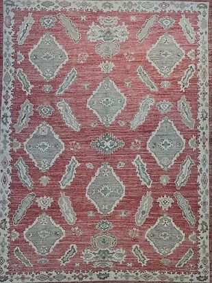 A red rug with a gray and white pattern on it.