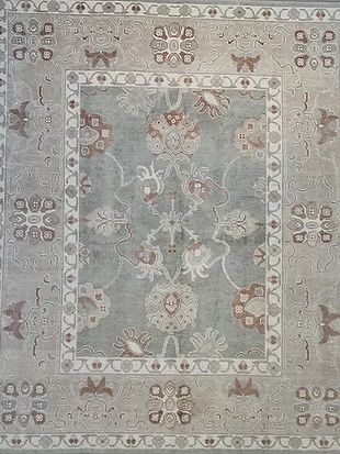 A close up of a rug with a floral pattern on it.