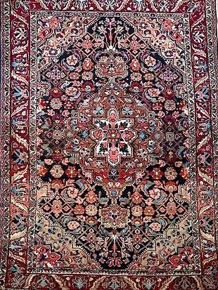 A close up of a rug with a floral pattern on it.