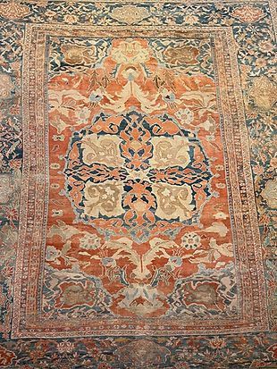A close up of a rug with a floral pattern on it.