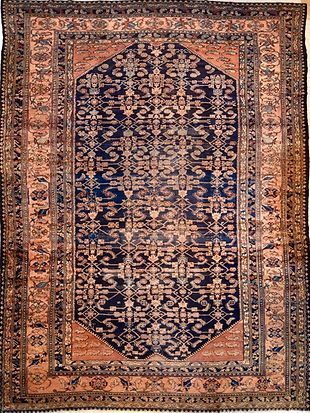 A rug with a pattern on it is hanging on a wall.