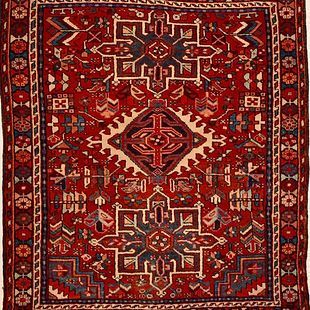 A red rug with a geometric pattern on it