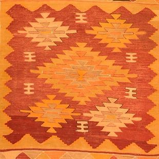 A close up of a rug with a geometric pattern on it.