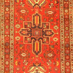A close up of a red rug with a pattern on it