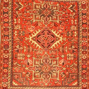 A close up of a red rug with a pattern on it.