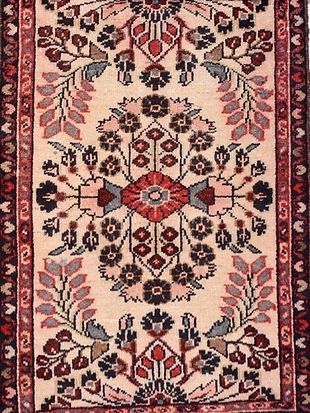 A close up of a rug with a floral pattern on it.