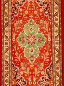 A red rug with a floral pattern on it