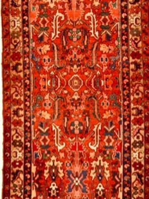 A red rug with a floral pattern on it