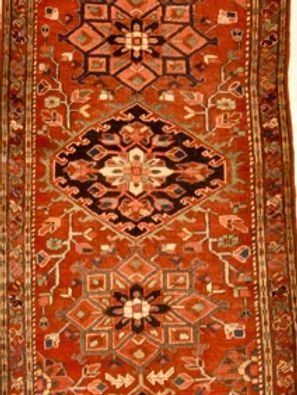 A red rug with a geometric pattern on it