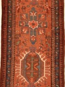 A red rug with a floral pattern on it