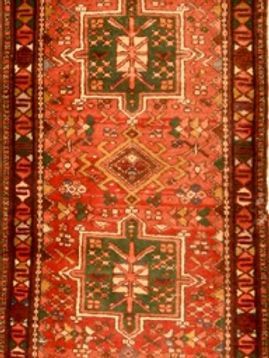 A red and green rug with a geometric pattern