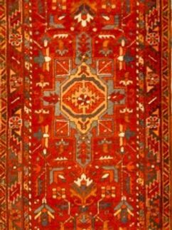A red rug with a geometric pattern on it