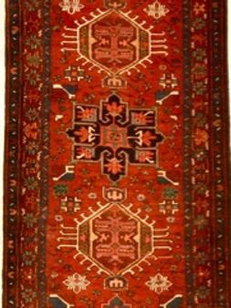 A red rug with a pattern that says e on it