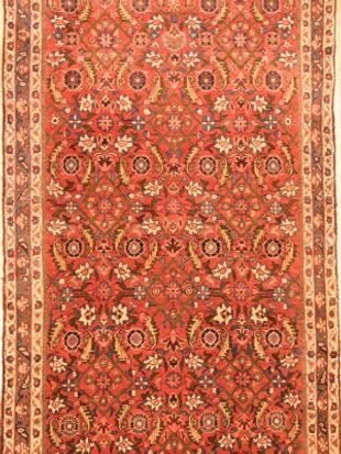 A red rug with a floral pattern on it.