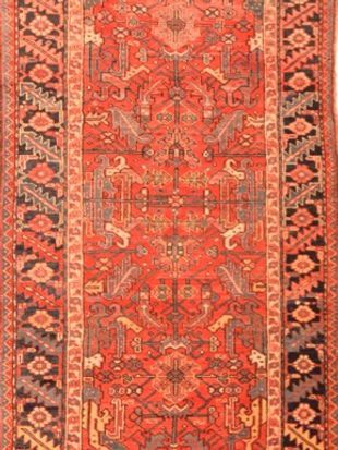 A close up of a red rug with a pattern on it