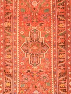 A red rug with a geometric pattern on it