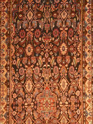 A close up of a rug with a floral pattern on it.