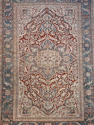 A close up of a rug with a floral pattern on it.