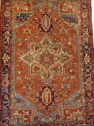 A close up of a rug with a pattern on it on a white background.