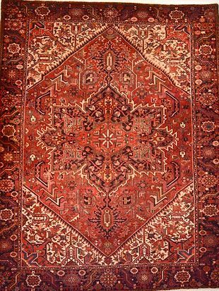 A close up of a red rug with a pattern on it.