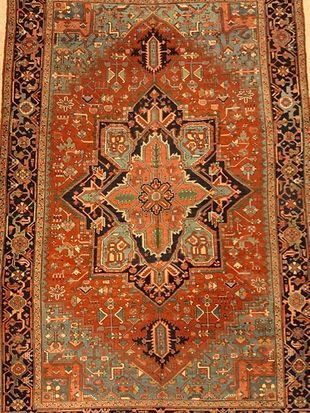 A close up of a rug with a floral pattern on it.