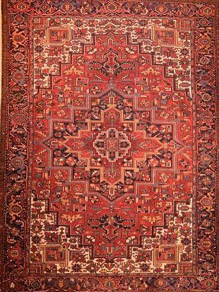 A close up of a red rug with a pattern on it.