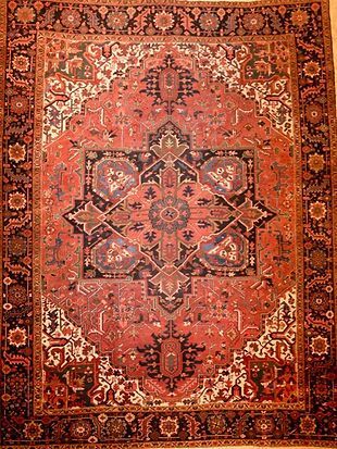 A close up of a rug with a floral pattern on it.