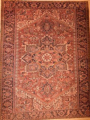 A rug with a floral pattern on it is sitting on a table.