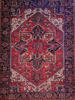 A close up of a red and blue rug with a pattern on it.