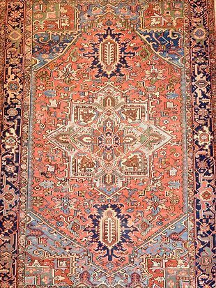 A close up of a rug with a floral pattern on it.