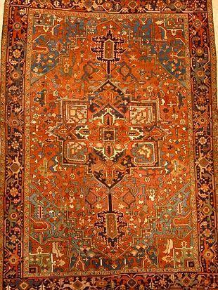 A close up of a rug with a floral pattern on it.