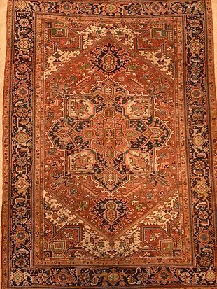 A rug with a floral pattern on it is sitting on a table.
