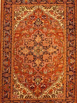 A close up of a rug with a floral pattern on it.