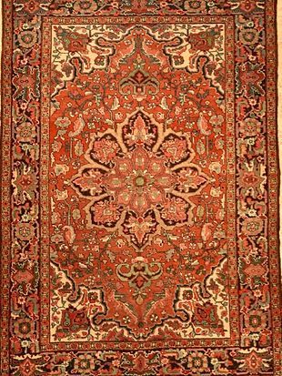 A close up of a rug with a floral pattern on it.
