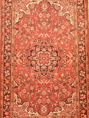 A close up of a rug with a floral pattern on it.