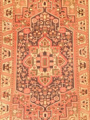 A close up of a rug with a pattern on it.