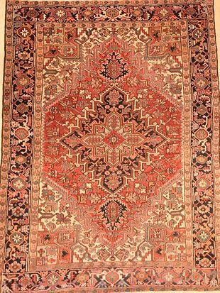 A red rug with a pattern on it is sitting on a table.