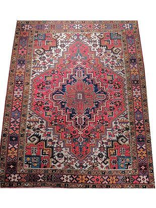 A colorful rug with a pattern on it is on a white background.