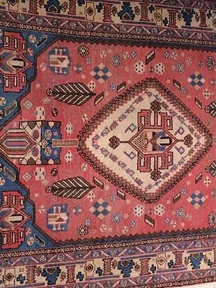 A close up of a rug with a floral pattern on it