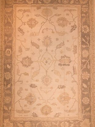 A rug with a floral pattern on it is sitting on a table.