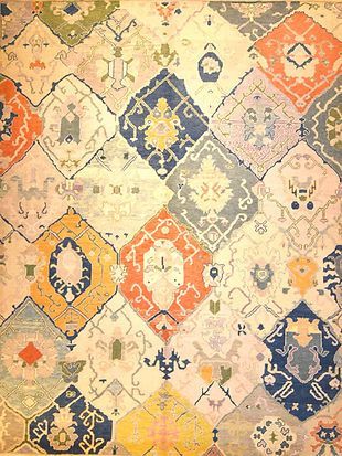 A close up of a colorful rug with a pattern on it.