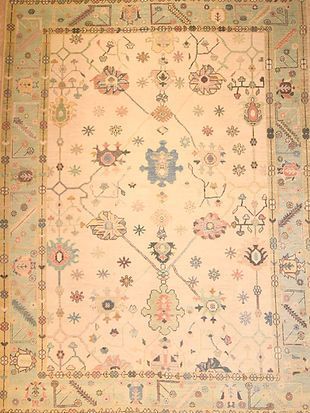 A rug with a floral pattern on it is sitting on a table.