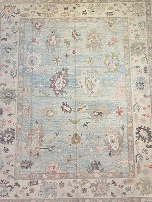 A blue and white rug with a floral pattern on it.