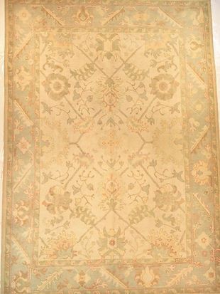 A rug with a floral pattern on it is hanging on a wall.