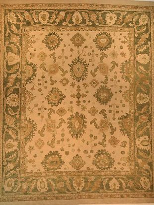 A rug with a floral pattern and a green border