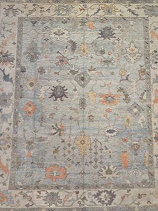 A close up of a rug with a floral pattern on it.