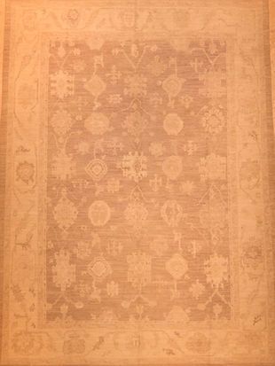 A rug with a floral pattern on it is sitting on a table.