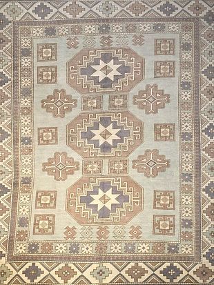 A rug with a geometric pattern on it is sitting on a table.