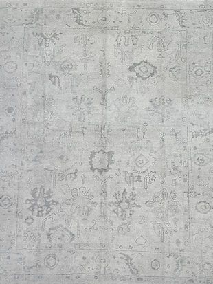 A close up of a gray rug with a pattern on it.