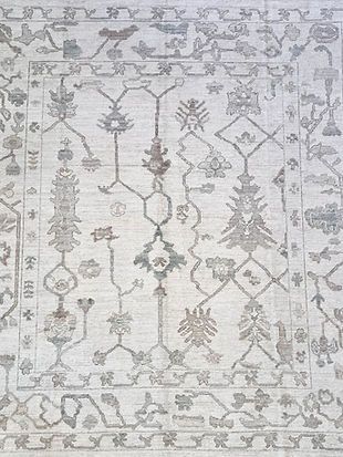 A close up of a rug with a floral pattern on it.